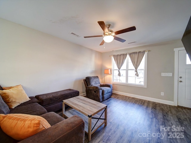 living room with ceiling fan and dark hardwood / wood-style flooring