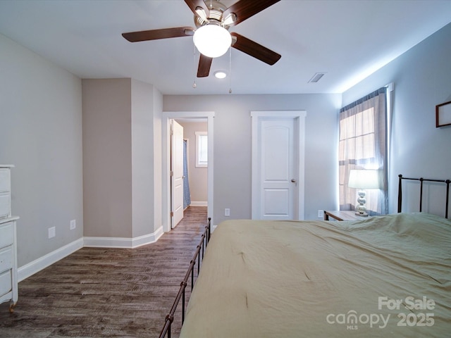 unfurnished bedroom featuring ceiling fan and dark hardwood / wood-style flooring