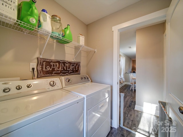 laundry area with dark wood-type flooring and washing machine and clothes dryer