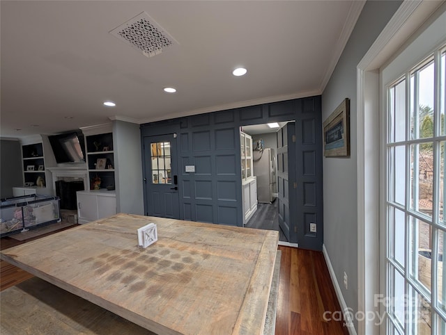 entryway featuring dark hardwood / wood-style floors and crown molding