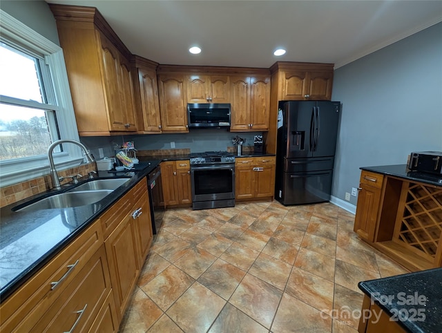 kitchen featuring crown molding, sink, dark stone countertops, and black appliances