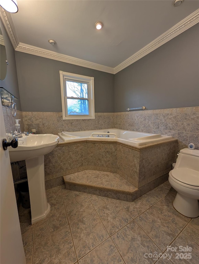 bathroom with toilet, ornamental molding, tile walls, and tile patterned floors