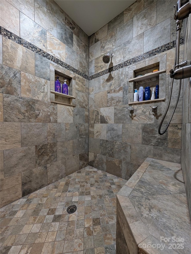 bathroom with tiled shower