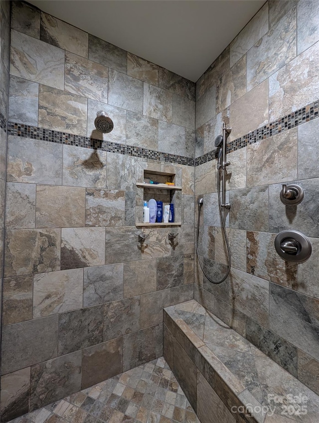 bathroom with a tile shower