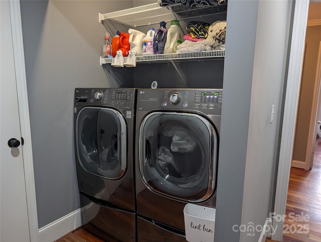 clothes washing area featuring hardwood / wood-style flooring and independent washer and dryer