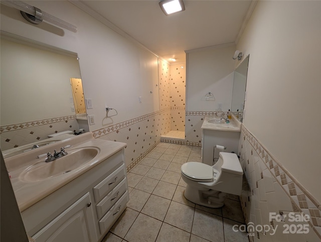 bathroom featuring tile walls, tile patterned floors, crown molding, and toilet