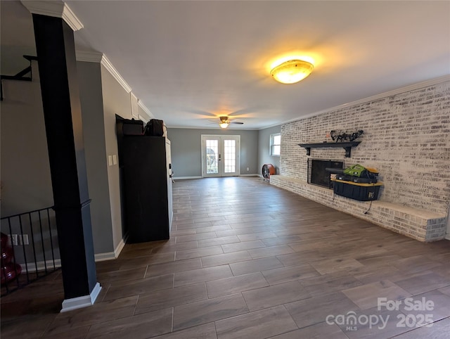 unfurnished living room featuring ceiling fan, ornamental molding, french doors, and a fireplace