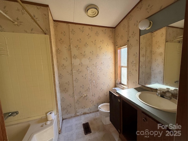 bathroom featuring toilet, vanity, and ornamental molding