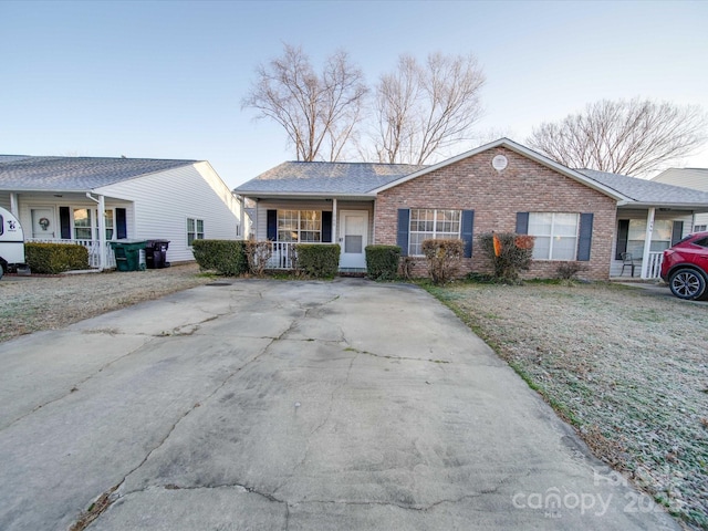 single story home with a porch