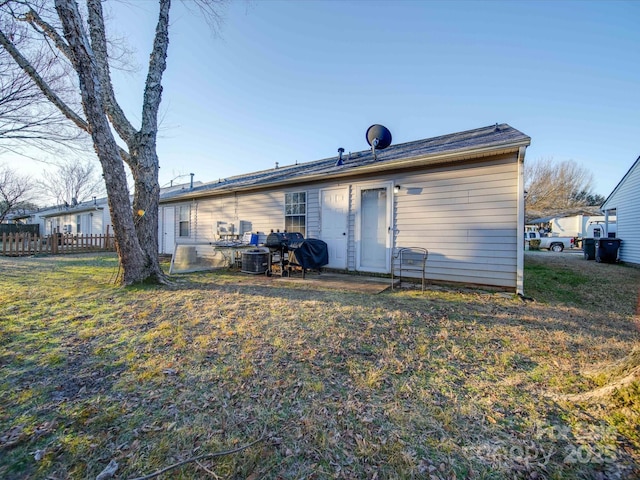 rear view of property with a lawn