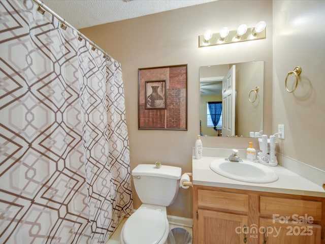 bathroom with a textured ceiling, toilet, and vanity