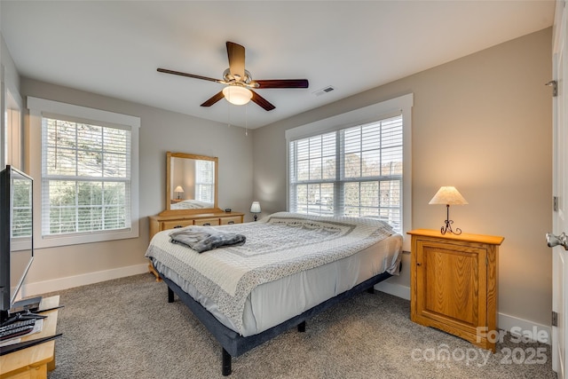 bedroom featuring ceiling fan, carpet floors, and multiple windows