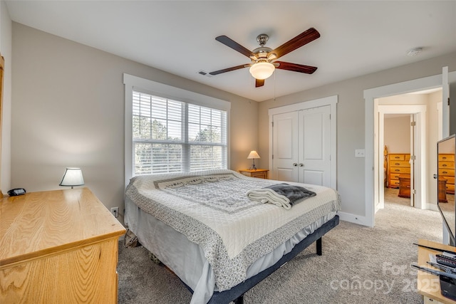 bedroom featuring ceiling fan, carpet flooring, and a closet