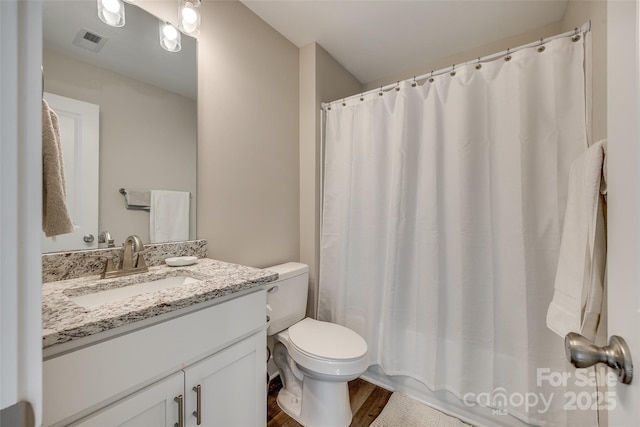 bathroom featuring hardwood / wood-style flooring, toilet, vanity, and a shower with shower curtain