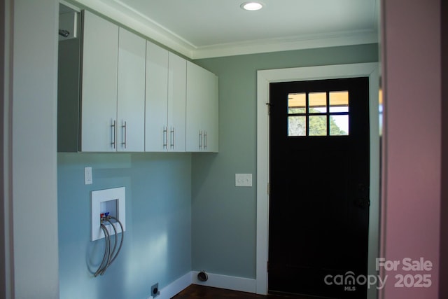 clothes washing area with washer hookup, cabinets, and ornamental molding