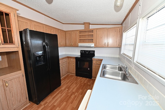 kitchen with black appliances, sink, crown molding, light hardwood / wood-style flooring, and a textured ceiling