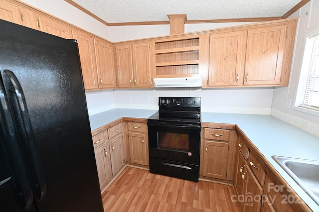 kitchen featuring light hardwood / wood-style floors, lofted ceiling, a textured ceiling, black appliances, and sink