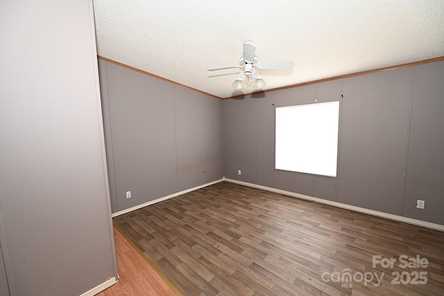 spare room with hardwood / wood-style flooring, a textured ceiling, ornamental molding, and ceiling fan