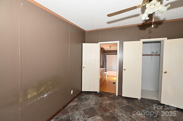 bedroom with a textured ceiling, ceiling fan, and ornamental molding