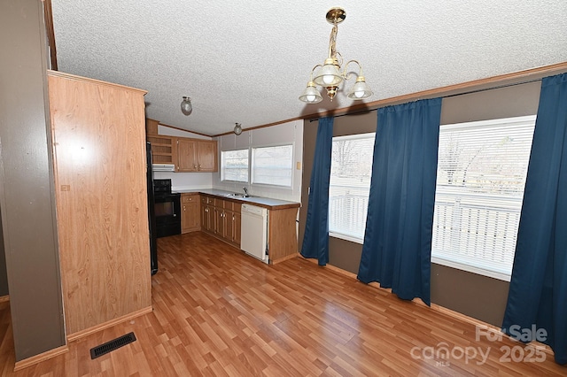 kitchen featuring a textured ceiling, dishwasher, decorative light fixtures, range with electric cooktop, and light wood-type flooring