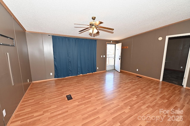 spare room with ceiling fan, ornamental molding, and light hardwood / wood-style flooring