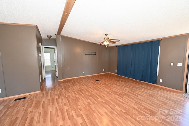 unfurnished room with ceiling fan, a textured ceiling, light hardwood / wood-style flooring, and ornamental molding