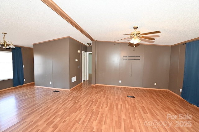 empty room with crown molding, a textured ceiling, and light hardwood / wood-style flooring