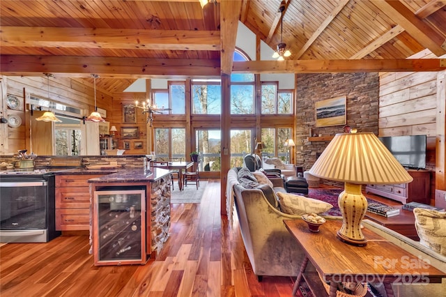 living room featuring beverage cooler, wood ceiling, wooden walls, light hardwood / wood-style floors, and high vaulted ceiling