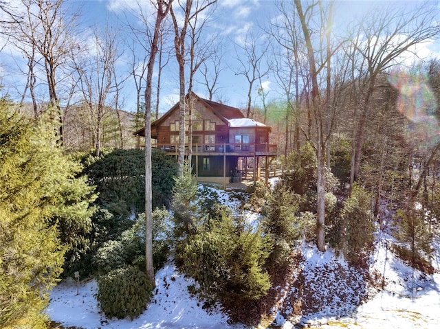 view of snow covered rear of property