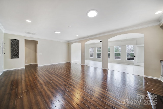 unfurnished living room featuring dark wood-type flooring, crown molding, and ceiling fan