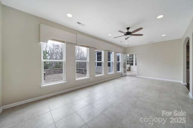 spare room featuring ceiling fan and light tile patterned flooring