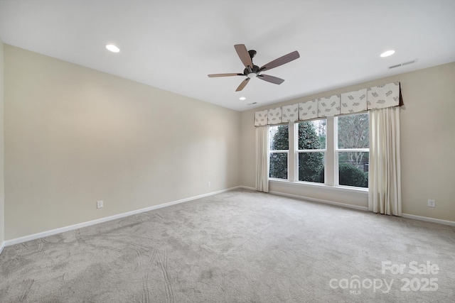 carpeted spare room featuring ceiling fan