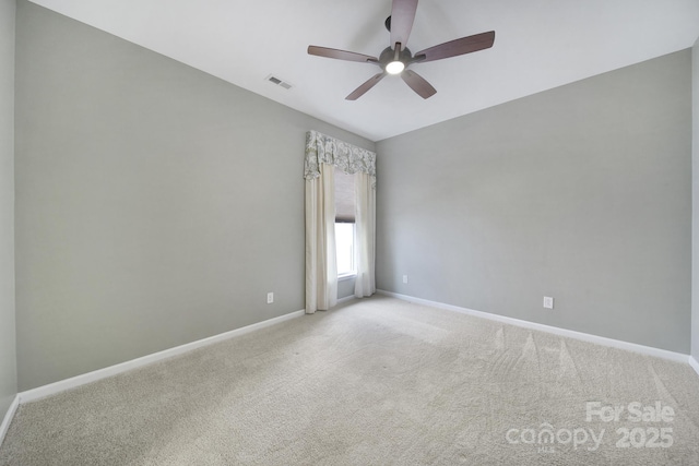 carpeted spare room featuring ceiling fan