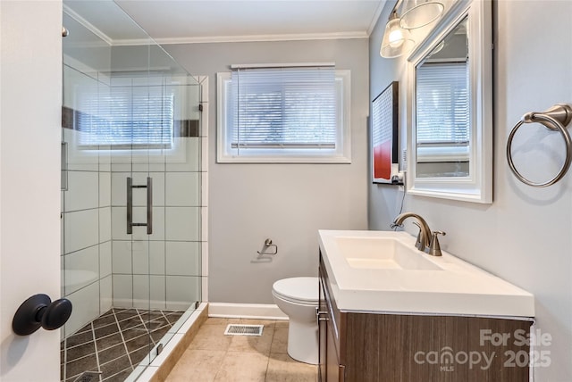 bathroom featuring ornamental molding, vanity, an enclosed shower, toilet, and plenty of natural light