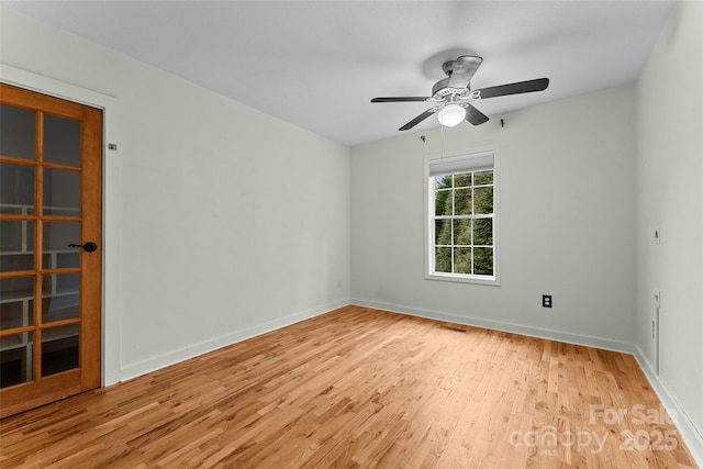 spare room with ceiling fan and light wood-type flooring