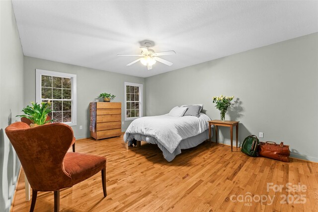 bedroom with ceiling fan and light hardwood / wood-style floors