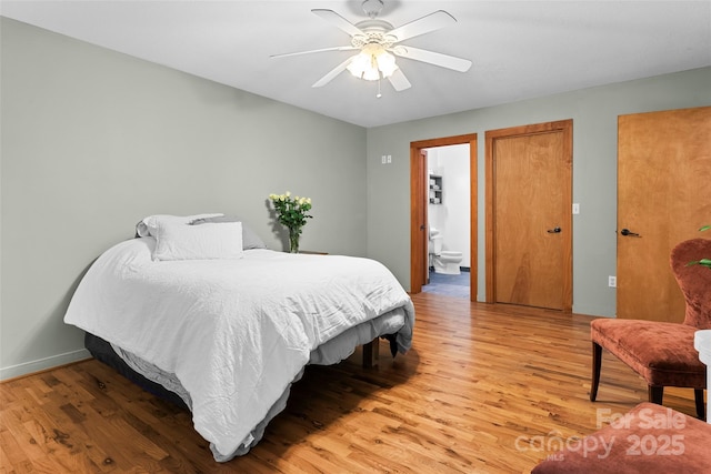 bedroom featuring hardwood / wood-style flooring, ceiling fan, and connected bathroom