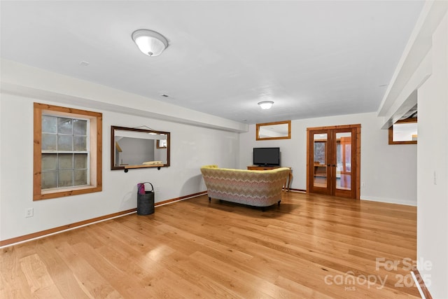 unfurnished living room featuring french doors and light wood-type flooring