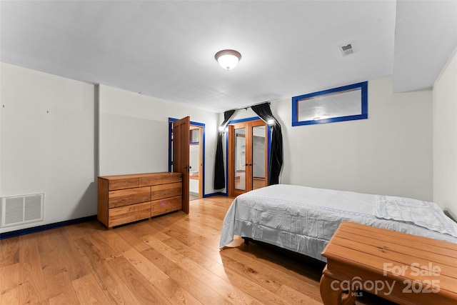 bedroom featuring access to exterior and light hardwood / wood-style floors