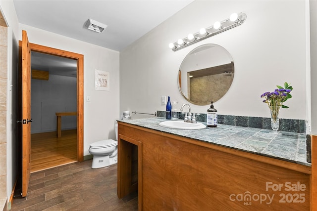 bathroom featuring vanity and toilet