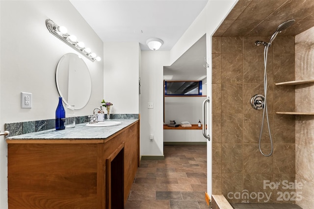 bathroom featuring vanity and tiled shower