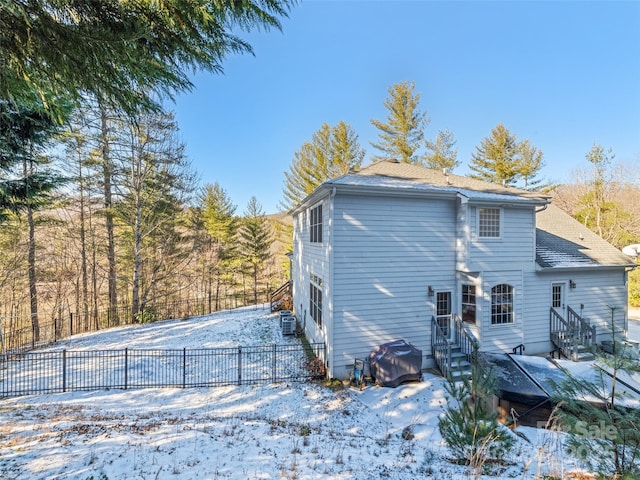 view of snow covered back of property