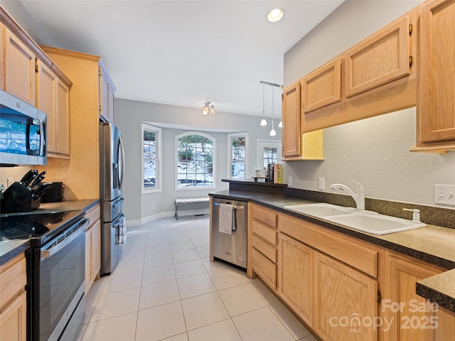 kitchen with sink, light brown cabinets, light tile patterned floors, and stainless steel appliances