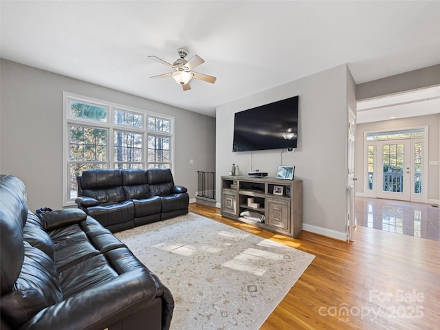 living room with ceiling fan and hardwood / wood-style flooring