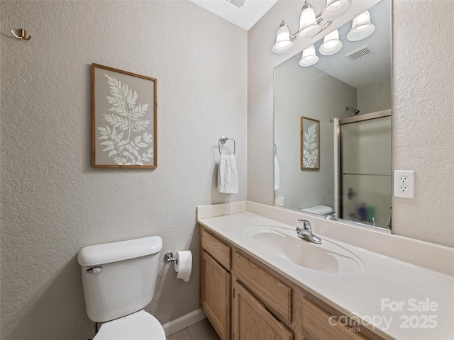 bathroom featuring toilet, walk in shower, and vanity