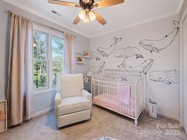 bedroom featuring ceiling fan, carpet, ornamental molding, and a crib