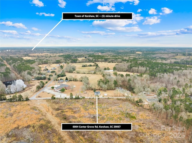 birds eye view of property with a rural view