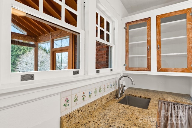 kitchen featuring lofted ceiling and sink