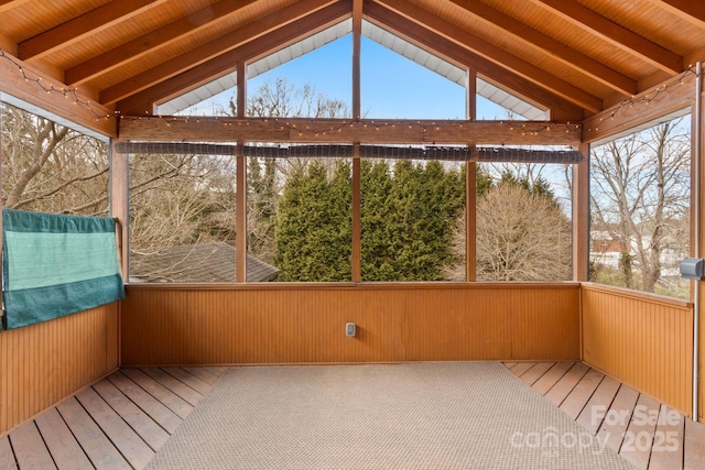 unfurnished sunroom with vaulted ceiling with beams and wooden ceiling