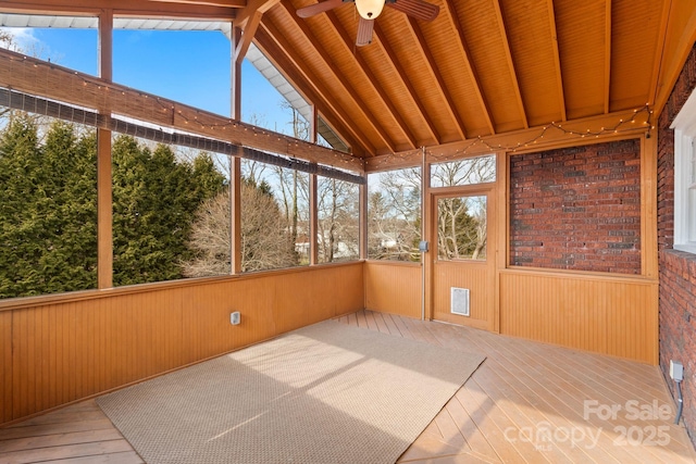 unfurnished sunroom featuring vaulted ceiling with beams, wooden ceiling, and ceiling fan